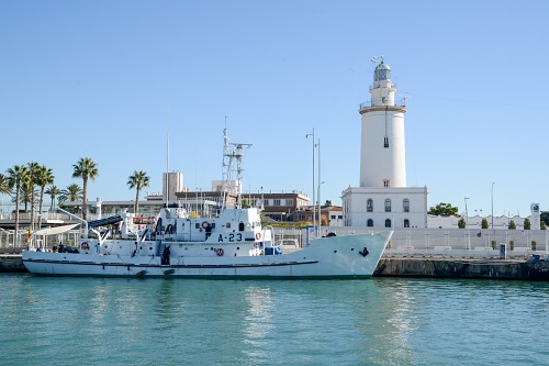 Whit ship next to lighthouse