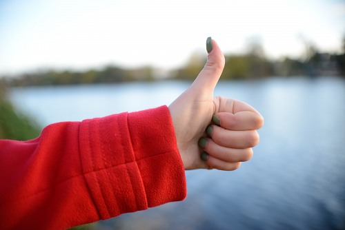 Young woman thumbs up free photo