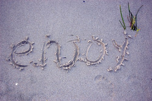 Enjoy written in sand free photo