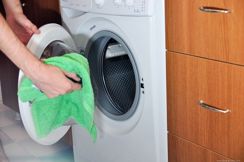 Inserting laundry in the washing machine free photo